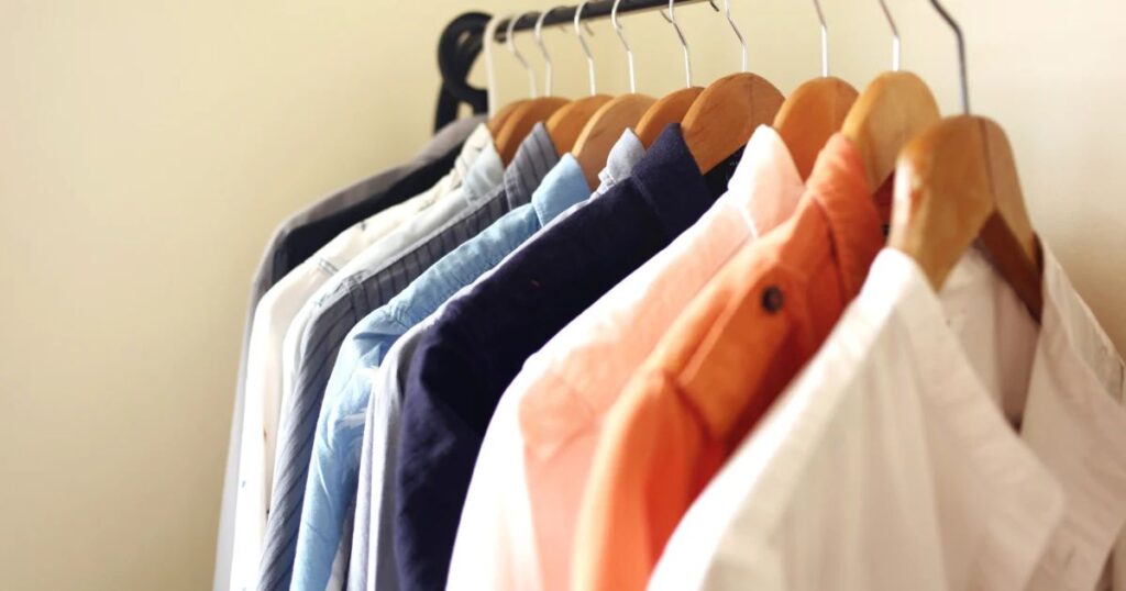 A rack of shirts hanging on a wall, showcasing styles to help you dominate your wardrobe with elegance and variety.